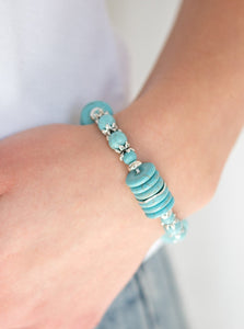 Featuring glistening silver accents, refreshing disc-shaped and round turquoise stone beads are threaded along a stretchy band for a seasonal look.  Sold as one individual bracelet. 