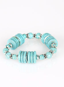 Featuring glistening silver accents, refreshing disc-shaped and round turquoise stone beads are threaded along a stretchy band for a seasonal look.  Sold as one individual bracelet. 