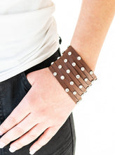 Load image into Gallery viewer, A thick brown leather band has been spliced into numerous brown strands. Featuring sleek silver frames, glittery white rhinestones are sprinkled across the leather bands for a sassy finish. Features an adjustable snap closure.  Sold as one individual bracelet.  