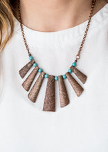 Load image into Gallery viewer, Etched in shimmery textures, glistening copper plates trickle along the bottom of a copper chain, creating a tribal inspired fringe below the collar. Refreshing turquoise stone beads trickle between the antiqued plates, adding an artisanal flair to seasonal palette. Features an adjustable clasp closure.  Sold as one individual necklace. Includes one pair of matching earrings.   