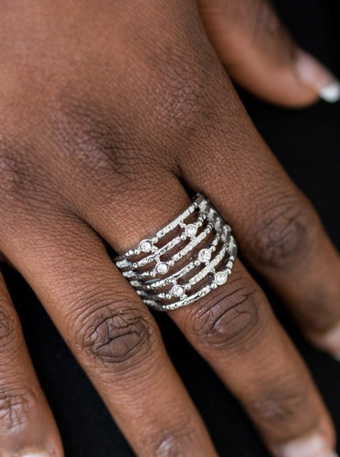 Delicately hammered in shimmer, dainty silver bars stack across the finger, coalescing into an airy band. Glittery white rhinestones dot the bands for a refined finish. Features a stretchy band for a flexible fit.  Sold as one individual ring.