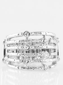 Delicately hammered in shimmer, dainty silver bars stack across the finger, coalescing into an airy band. Glittery white rhinestones dot the bands for a refined finish. Features a stretchy band for a flexible fit.  Sold as one individual ring.