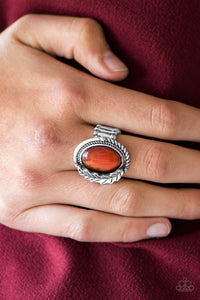 A luminescent orange moonstone is pressed into the center of a textured silver frame. Brushed in a glistening finish, a leafy silver charm adorns one side of the stone for a seasonal finish. Features a stretchy band for a flexible fit.  Sold as one individual ring.  Always nickel and lead free.