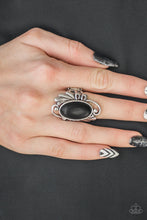 Load image into Gallery viewer, Chiseled into a smooth oval, an earthy black stone is pressed into the center of a glistening silver frame radiating with filigree detail for a seasonal look. Features a stretchy band for a flexible fit.  Sold as one individual ring.  Always nickel and lead free.