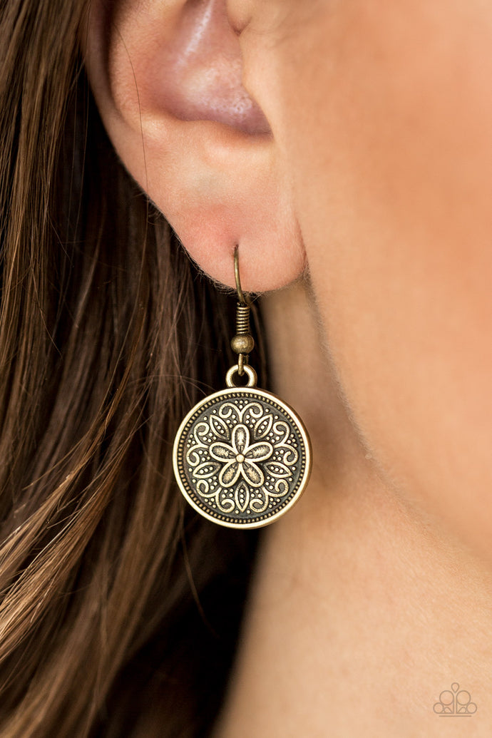 Embossed in a leafy floral pattern, a dainty brass frame swings from the ear in a seasonal fashion. Earring attaches to a standard fishhook fitting.  Sold as one pair of earrings.  Always nickel and lead free.