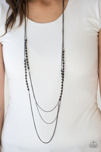 Brushed in a metallic sheen, glittery black crystal-like beads join faceted silver beads along layers of shimmery silver chains for a refined look. Features an adjustable clasp closure.  Sold as one individual necklace. Includes one pair of matching earrings.