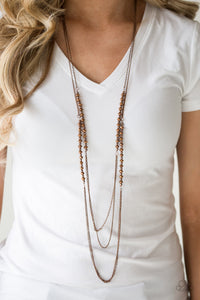 Brushed in a metallic sheen, coppery crystal-like beads join faceted copper beads along layers of shimmery copper chains for a refined look. Features an adjustable clasp closure.  Sold as one individual necklace. Includes one pair of matching earrings.   Always nickel and lead free.