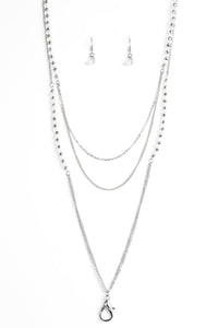 Featuring glassy and opaque finishes, white crystal-like beads join faceted silver beads along shimmery silver chains for a refined look. A lobster clasp hangs from the bottom of the design to allow a name badge or other item to be attached. Features an adjustable clasp closure.  Sold as one individual lanyard. Includes one pair of matching earrings.