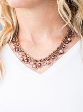 Load image into Gallery viewer, Brushed in an antiqued shimmer, mismatched copper hoops, copper pearls, and dainty copper beads swing from the bottom of a bold copper chain below the collar for a refined look. Features an adjustable clasp closure.  Sold as one individual necklace. Includes one pair of matching earrings.   