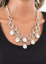 Load image into Gallery viewer, Joined by dainty silver links, two rows of dramatic silver chain layer below the collar in a fierce fashion. Glittery white teardrops drip from the glistening layers, adding a timeless shimmer to the show-stopping piece. Features an adjustable clasp closure.  Sold as one individual necklace. Includes one pair of matching earrings.