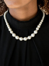 Load image into Gallery viewer, Gradually increasing in size near the bottom, classic white pearls drape below the collar. Rhinestone encrusted rings are sprinkled between the dramatic pearls, adding sparkling accents to the timeless pearl palette. Features an adjustable clasp closure.  Sold as one individual necklace. Includes one pair of matching earrings.