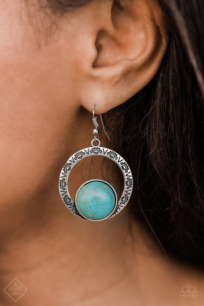 A refreshing turquoise stone is pressed into the bottom of a delicately hammered silver hoop stamped with intricate tribal patterns. The contrasting elements combine to create an artisan-inspired statement piece. Earring attaches to a standard fishhook fitting.  Sold as one pair of earrings.  Complete the look with other pieces from the collection  Simply Santa Fe Fashion Fix April 2019    Always nickel and lead free.