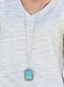 Chiseled into a tranquil rectangle, a turquoise stone is pressed into a shimmery silver frame swirling with texture for an artisan-inspired look. The earthy pendant swings from the bottom of a lengthened silver chain for a seasonal finish. Features an adjustable clasp closure.  Sold as one individual necklace. Includes one pair of matching earrings. 
