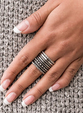 Load image into Gallery viewer, Layers of texture - from rows of dots to twisted ropes to high sheen hammered silver - stack together in a bold display. Features a stretchy band for a flexible fit.