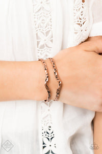 Delicately hammered in antiqued shimmer, glistening copper bars arc across the wrist, coalescing into an airy cuff.