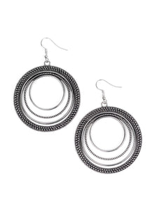 Radiating with smooth, studded, and rope-like textures, a collection of silver hoops ripple into a bold statement piece. Earring attaches to a standard fishhook fitting. Sold as one pair of earrings.