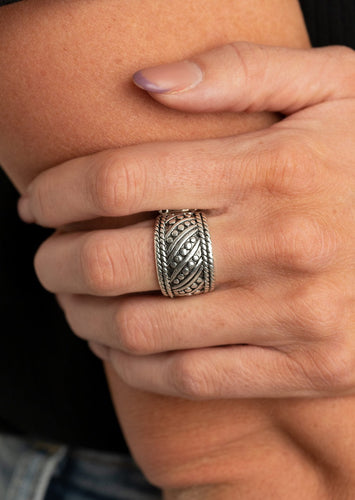 Studded and smooth silver bars delicately slant across the finger between two borders of silver rope-like texture, coalescing into an edgy band. Features a stretchy band for a flexible fit.  Sold as one individual ring.    