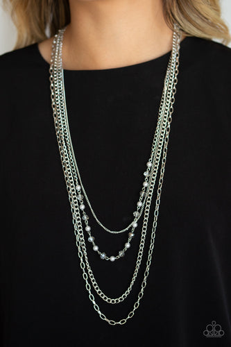   A collection of glistening mismatched silver chains drape across the chest. Dotted with dainty silver pearly and glassy crystal-like beads, a glittery strand flawlessly drapes across the layers for a timeless finish. Features an adjustable clasp closure.  Sold as one individual necklace. Includes one pair of matching earrings. Always nickel and lead free.