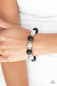 A collection of white rhinestone encrusted rings, shiny black beads, and classic silver beads are threaded along a stretchy band around the wrist for a glamorous look.  Sold as one individual bracelet. Always nickel and lead free.