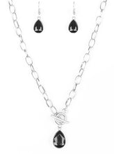 Load image into Gallery viewer, A faceted black teardrop gem swings from the bottom of a shimmery silver chain, creating a classic pendant below the collar. Features a toggle closure.  Sold as one individual necklace. Includes one pair of matching earrings.