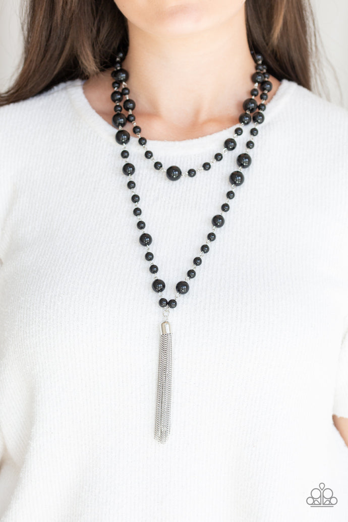 A collection of bubbly black beads link into two strands down the chest. A shimmery silver tassel swings from the lowermost strand, adding a timeless twist to the classic beaded palette. Features an adjustable clasp closure.  Sold as one individual necklace. Includes one pair of matching earrings.   Always nickel and lead free.