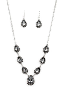 Featuring ornate silver frames, smoky teardrop gems link below the collar in a timeless fashion. The largest teardrop swings from the center, creating a glamorous pendant. Features an adjustable clasp closure.  Sold as one individual necklace. Includes one pair of matching earrings.