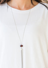 Load image into Gallery viewer, A glittery brown crystal-like bead swings from the bottom of a lengthened silver chain, giving way to a shimmering silver tassel for a glamorous finish. Features an adjustable clasp closure.  Sold as one individual necklace. Includes one pair of matching earrings.  Always nickel and lead free.
