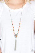 Load image into Gallery viewer, Polished and crystal-like orange beads trickle along a shimmery silver chain, giving way to a glistening teardrop pendant. Infused with studded detail and a matching orange beaded center, the ornate pendant gives way to a shimmery silver chain tassel for a wanderlust finish. Features an adjustable clasp closure.  Sold as one individual necklace. Includes one pair of matching earrings.  Always nickel and lead free.