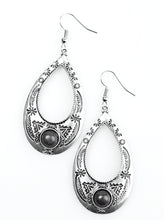 Load image into Gallery viewer, Stamped in tribal inspired patterns, a glistening silver teardrop swings from the ear in a whimsical fashion. A smooth black stone is pressed into the bottom of the frame, adding an earthy flair to the indigenous lure. Earring attaches to a standard fishhook fitting.  Sold as one pair of earrings.