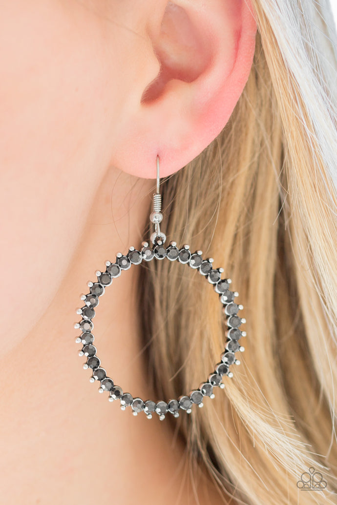 Smoky rhinestones are encrusted along a studded silver hoop for an edgy-glamorous look. Earring attaches to a standard fishhook fitting.  Sold as one pair of earrings.  Always nickel and lead free.