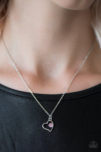 A solitaire pink rhinestone sits off center inside of a silver heart frame, creating a timeless pendant below the collar. Features an adjustable clasp closure.  Sold as one individual necklace. Includes one pair of matching earrings. Always nickel and lead free.