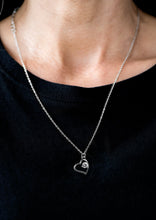 Load image into Gallery viewer, A solitaire white rhinestone sits off center inside of a silver heart frame, creating a timeless pendant below the collar. Features an adjustable clasp closure.  Sold as one individual necklace. Includes one pair of matching earrings.