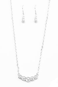 Pressed in glistening silver frames, glittery white rhinestones join into a subtlety bowing pendant below the collar for a refined fashion. Features an adjustable clasp closure.  Sold as one individual necklace. Includes one pair of matching earrings.