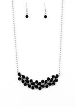 Load image into Gallery viewer, A collection of round and teardrop black rhinestones coalesce into a bowing silver pendant below the collar for a refined look. Features an adjustable clasp closure.  Sold as one individual necklace. Includes one pair of matching earrings.