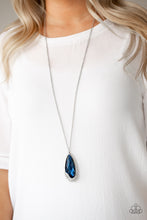 Load image into Gallery viewer, An oversized blue teardrop gem is nestled inside of an abstract silver frame that has been dipped in glassy white rhinestones. The spellbinding pendant swings from the bottom of a lengthened silver chain for a glamorous finish. Features an adjustable clasp closure.  Sold as one individual necklace. Includes one pair of matching earrings.