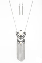 Load image into Gallery viewer,   Featuring refreshing white stone accents, ornate silver plates link at the bottom of a lengthened silver chain for a dramatic tribal look. Shimmery silver chains stream from the bottom of the stacked pendant, adding a wanderlust flair to the seasonal palette. Features an adjustable clasp closure.  Sold as one individual necklace. Includes one pair of matching earrings.  