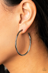 Featuring flattened sections, a textured gunmetal hoop boldly curls around the ear for an edgy flair. Earring attaches to a standard post fitting. Hoop measures approximately 1 3/4" in diameter.  Sold as one pair of hoop earrings.  Always nickel and lead free.