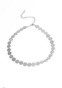 Delicately scratched in linear shimmer, dainty silver discs link around the neck for a blinding metallic look. Features an adjustable clasp closure.  Sold as one individual choker necklace. Includes one pair of matching earrings.
