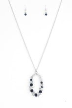 Load image into Gallery viewer, Varying in size, an array of glittery white and blue rhinestones are encrusted along a shimmery silver hoop. The sparkling pendant swings from the bottom of an elongated silver chain for a glamorous finish. Features an adjustable clasp closure.  Sold as one individual necklace. Includes one pair of matching earrings.