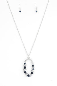 Varying in size, an array of glittery white and blue rhinestones are encrusted along a shimmery silver hoop. The sparkling pendant swings from the bottom of an elongated silver chain for a glamorous finish. Features an adjustable clasp closure.  Sold as one individual necklace. Includes one pair of matching earrings.