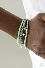 Load image into Gallery viewer, Polished green and classic silver beads are threaded along stretchy elastic bands, creating colorful layers across the wrist. Decorative silver beads and dainty silver hearts swing from the wrist for a whimsical finish.  Sold as one set of three bracelets.  Always nickel and lead free.