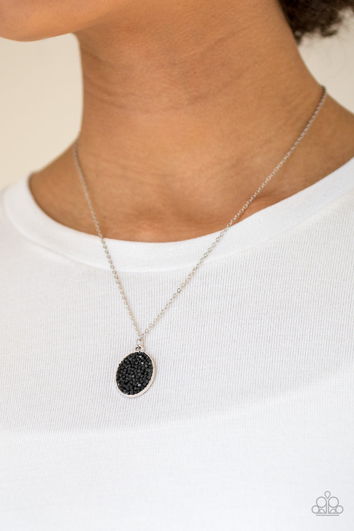 Glittery black rhinestones are sprinkled along an oval silver frame, creating a stellar pendant below the collar. Features an adjustable clasp closure.  Sold as one individual necklace. Includes one pair of matching earrings.  Always nickel and lead free.