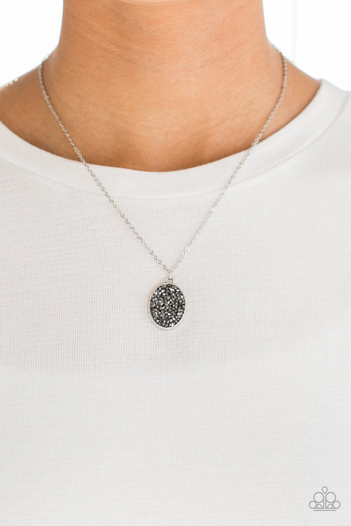 Glittery hematite and smoky rhinestones are sprinkled along an oval silver frame, creating a stellar pendant below the collar. Features an adjustable clasp closure.  Sold as one individual necklace. Includes one pair of matching earrings.  Always nickel and lead free.