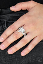 Load image into Gallery viewer, Dotted with a fiery red rhinestone, a dainty silver star joins a white rhinestone encrusted star atop a glistening silver band, creating a stellar centerpiece. Features a dainty stretchy band for a flexible fit.  Sold as one individual ring. 