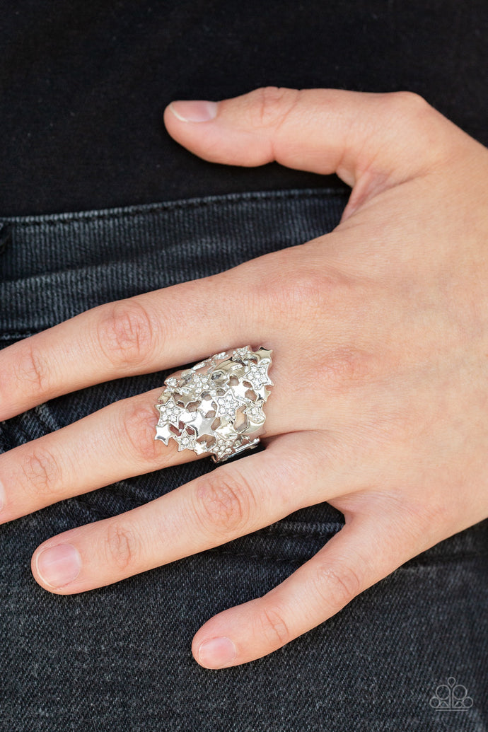 Encrusted in dainty white rhinestones, a collision of shimmery silver stars explode across the finger. Features a stretchy band for a flexible fit.  Sold as one individual ring.  Always nickel and lead free.