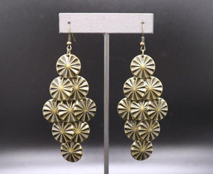 Embossed in star pattern, a glistening collection of brass discs cascade from the ear for an edgy look. Earring attaches to a standard fishhook fitting.  Sold as one individual earrings.  Always nickel and lead free.  September 2020 Fashion Fix Exclusive
