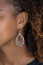 Load image into Gallery viewer, Shiny silver frames layer into an asymmetrical silver teardrop. A ribbon of glittery multicolored rhinestones wraps around the bottom for a refined finish. Earring attaches to a standard fishhook fitting.  Sold as one pair of earrings.  Always nickel and lead free