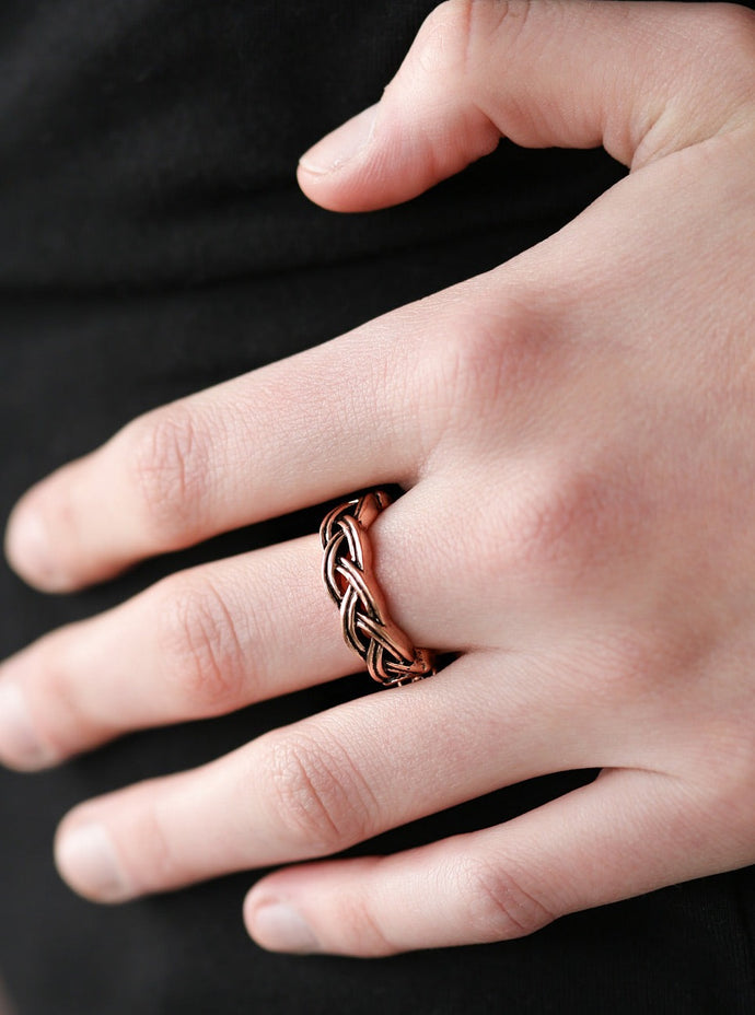 Brushed in an antiqued finish, glistening copper bars braid across the finger, creating an airy band. Features a dainty stretchy band for a flexible fit.  Sold as one individual ring.