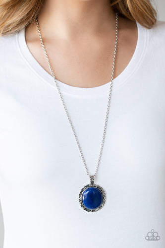 A glassy blue stone is pressed into the center of an ornate silver frame embossed in a leafy filigree pattern. The whimsical pendant swings from the bottom of a lengthened silver chain for a seasonal finish. Features an adjustable clasp closure.  Sold as one individual necklace. Includes one pair of matching earrings.  Always nickel and lead free.
