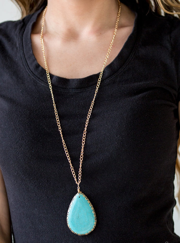 Chiseled into a tranquil teardrop, a smooth turquoise stone swings from the bottom of a glistening gold chain, creating a dramatically earthy pendant. Features an adjustable clasp closure.  Sold as one individual necklace. Includes one pair of matching earrings.  